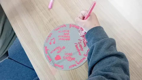 Link to Change A child writing on a wheel, with an arm outstretched. 
