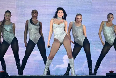 Getty Images Dua Lipa and her dancers stand in formation during her show at Wembley Stadium