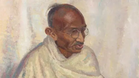 Bonhams An oil painting of Mahatma Gandhi where he has a white cloth draped around his torso and is wearing round glasses 