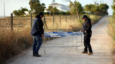 Reuters Police officers move a barrier blocking a road