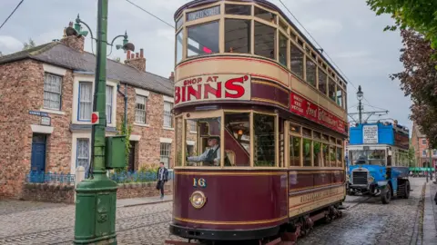 Getty Images Visitors travel on a vintage electric tram in the 1900s village at Beamish Museum on August 28, 2024 in Stanley, United Kingdom