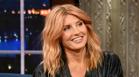Getty Images Sharon Horgan on The Late Show in November 2024. She has long strawberry blonde hair and is wearing a black dress.
