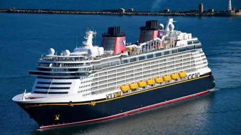 Getty Images The Disney Dream cruise ship seen in the water. It has a waterslide on top and has 14 decks