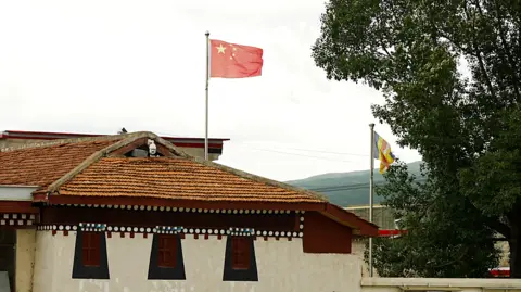 Xiqing Wang/ BBC The Chinese national flag above the Kirti monastery