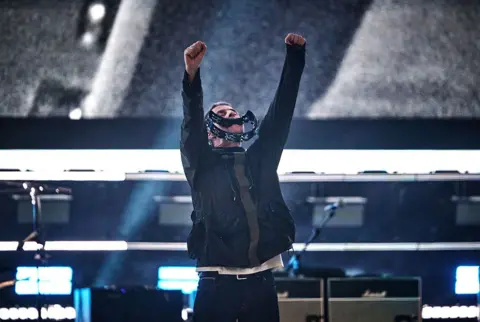 Getty Images Liam Gallagher holds a tambourine in his mouth