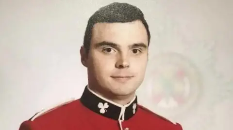FAMILY HANDOUT L/Cpl Bernard Mongan wearing red army uniform, with short brown hair