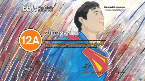 BBFC Superman, drawn in his iconic blue, red, and yellow costumer. He is emerging from a background of multicoloured streaks. The word 'Superman' and an orange circle around the digits '12A' overlays the design.