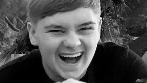 Family handout Black and white close-up of Harvey Willgoose, laughing and looking at the camera