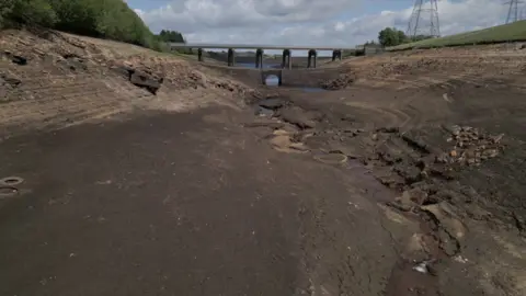 BBC A drone shot of Baitings Reservoir near Ripponden. The bed is entirely exposed and dry.