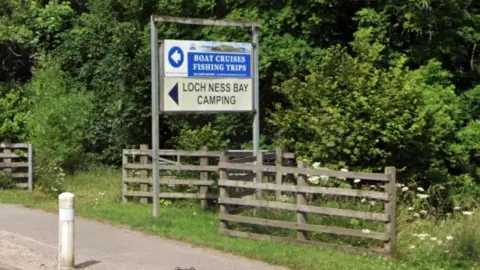 Google A sign saying Loch Ness Bay Camping beside a road