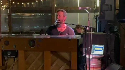 Jodie Smith Chris Martin playing the piano and smiling at the  Puzzle Hall Inn in Calderdale