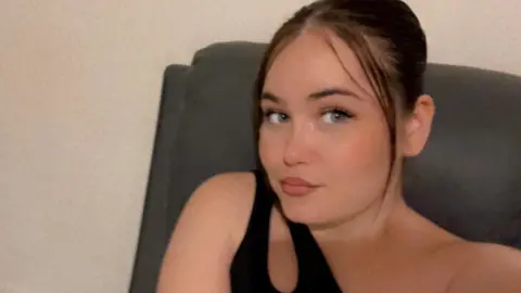 Supplied A selfie style image of Courtney Mitchell. She is wearing a black top and looking into the camera.