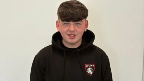 A photo of a pupil wearing a black West calder hoodie