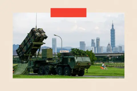 Ritchie B Tongo/ EPA/Shutterstock A person bikes past Taiwan military Patriot air defense system deployed at a park as part of the annual Han Kuang military exercises, in Taipei
