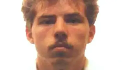 Cleveland Police A photograph provided by Cleveland Police showing William 'Billy' Dunlop, who killed Julie Hogg in 1989. In the photo, Dunlop who has blonde medium-length hair and a full moustache, stares at the camera with no facial expression. 