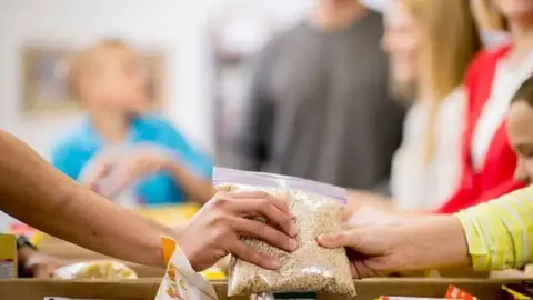Getty Images Generic photo of people at a food bank 