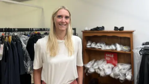 woman in front of school uniform sale