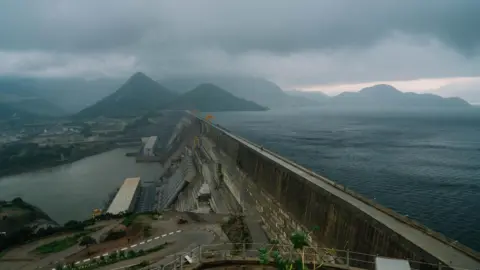 Office of Ethiopia's Prime Minister The completed dam. On one side of the wall is a vast lake and on the other side is industrial infrastructure.