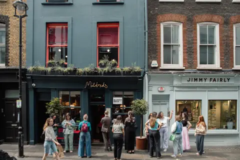 Mildred's People outside Mildred's restaurant
