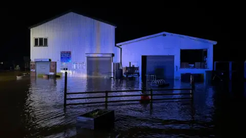 Rob's Furniture Robbie Laing's furniture shop in Builth Wells, Powys under water during storm Bert