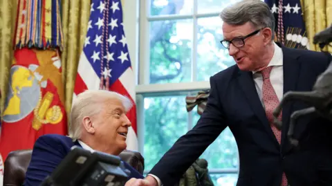 Reuters A smiling Donald Trump shakes hands with Mandelson in the Oval Office. 