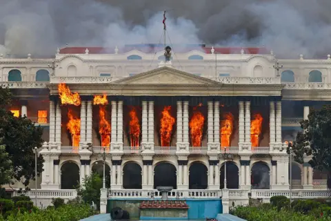 AFP via Getty Images Fire rages through the Singha Durbar, the main administrative building for the Nepal government, in Kathmandu on September 9, 2025, a day after a police crackdown on demonstrations over social media prohibitions and corruption by the government.