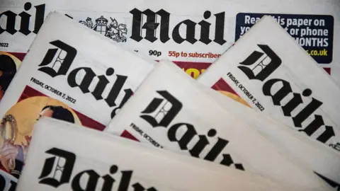 Getty Images Multiple copies of the "Daily Mail" newspaper are laid out in a slightly overlapping arrangement. Each front page displays the date "Friday, October 7, 2022." The image emphasizes the branding and layout of the newspaper editions.