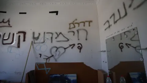 Graffit on walls inside an apartment includes lewd images of penises