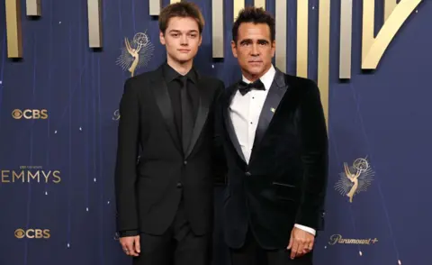 Getty Images Irish actor Colin Farrell (R) and his son Henry Farrell arrive for the 77th Primetime Emmy Awards at the Peacock Theatre at LA Live in Los Angeles on September 14, 2025. 