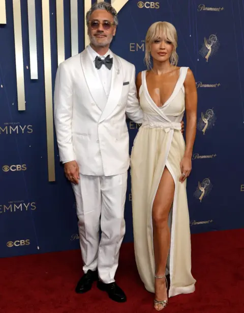 Getty Images Taika Waititi and Rita Ora attend the 77th Primetime Emmy Awards at Peacock Theater on September 14, 2025 in Los Angeles, California
