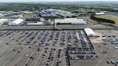 PA Media A view of vehicles at the Jaguar Land Rover facility in Gaydon, Warwickshire