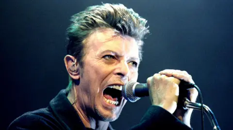 Reuters British Pop Star David Bowie screams into the microphone as he performs on stage
