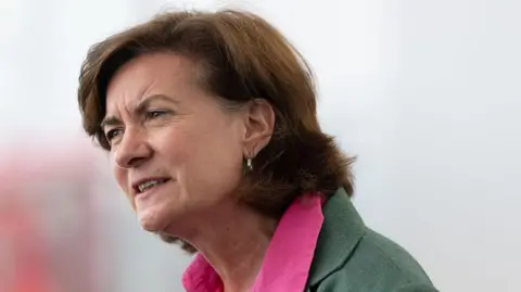Getty Images A head and shoulders photograph image of Eluned Morgan looking out of shot. The background is blurred.