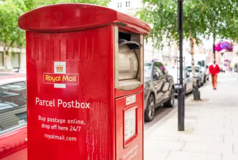 Getty Images A red Royal Mail postbox. It reads: 'Parcel postbox. Buy postage online, drop off here 24/7.'