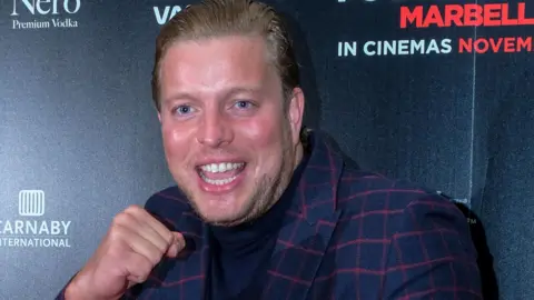 Getty Images Thomas Skinner smiling and in a boxing pose at the premiere of Rise of the Footsoldier 4 : Marbella in 2019