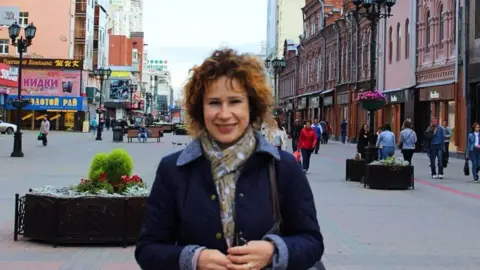 Viasna/Odnoklassiki Julia Fenner smiling at the camera while standing in a shopping street