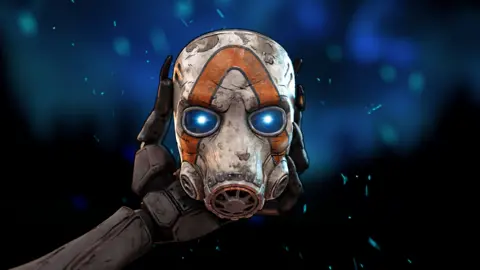 2K/Gearbox A robotic hand holds up the battle-damaged gas mask that has been a symbol of the Borderlands video games series since its first entry in 2009.